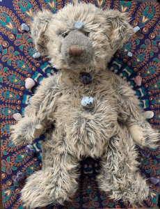 Teddy bear surrounded by crystals as a surrogate for a crystal healing session
